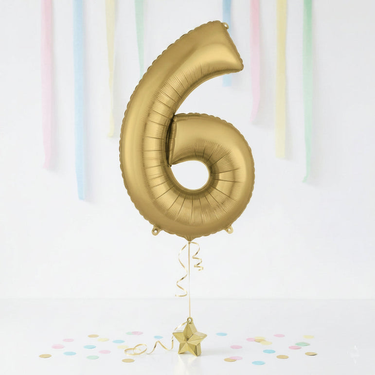 Gold number 6 balloon with a star-shaped balloon on a white background with colorful streamers.