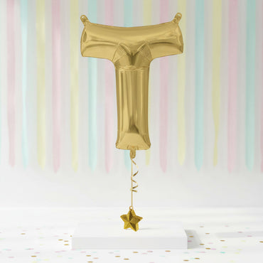 Gold foil balloon shaped like a letter 'T' with a star on a pastel striped background - Party Centre